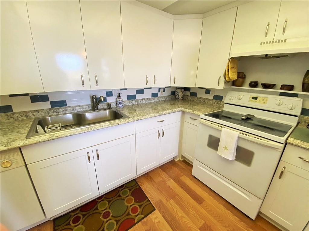 4055 Newcastle A, Unit 4055 Boca Raton, FL 33434 - Photo 21 of 23 a kitchen with a sink and cabinets