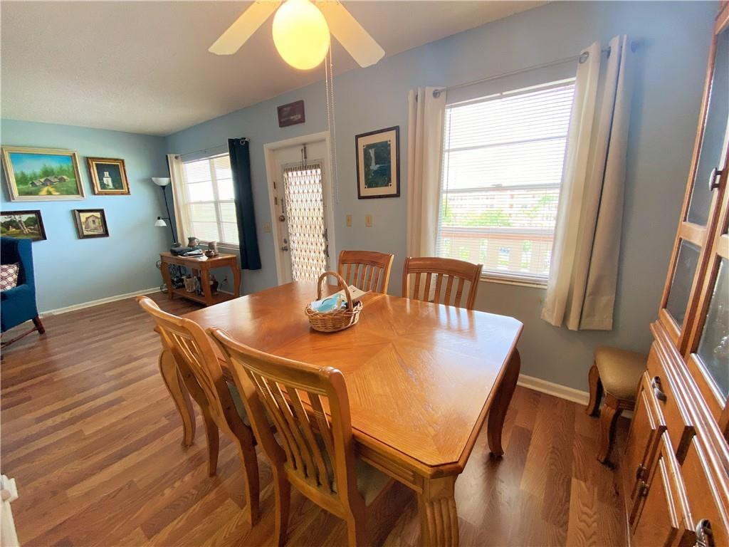 4055 Newcastle A, Unit 4055 Boca Raton, FL 33434 - Photo 22 of 23 a view of a dining room with furniture and wooden floor