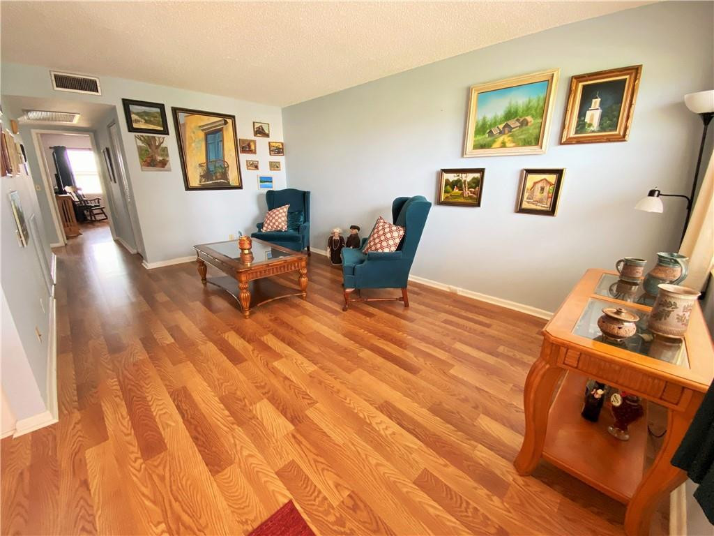 4055 Newcastle A, Unit 4055 Boca Raton, FL 33434 - Photo 4 of 23 a living room with furniture and wooden floor