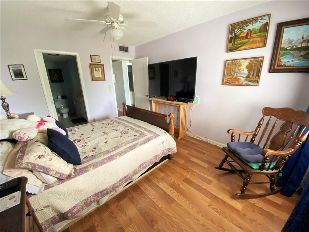 4055 Newcastle A, Unit 4055 Boca Raton, FL 33434 - Photo 7 of 23 a bedroom with a bed and a flat screen tv