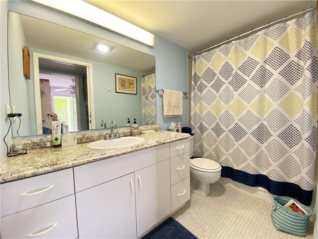 4055 Newcastle A, Unit 4055 Boca Raton, FL 33434 - Photo 9 of 23 a bathroom with a sink and a toilet