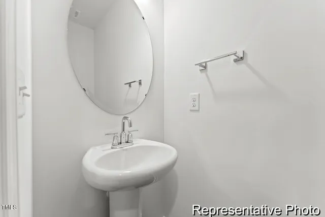 a bathroom with a sink and mirror