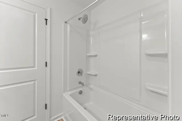 a bathroom with a bathtub a toilet and a shower