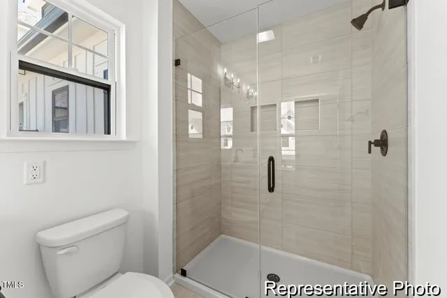 a bathroom with a shower a toilet and a shower