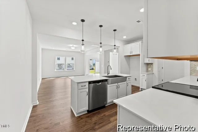 a large kitchen with kitchen island a sink stainless steel appliances and cabinets