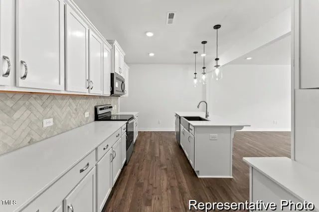a kitchen with a sink a counter space and appliances