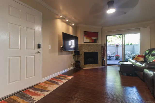 a living room with furniture fireplace and flat screen tv