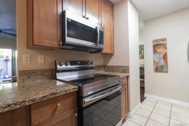 a kitchen with stainless steel appliances granite countertop a stove and a microwave