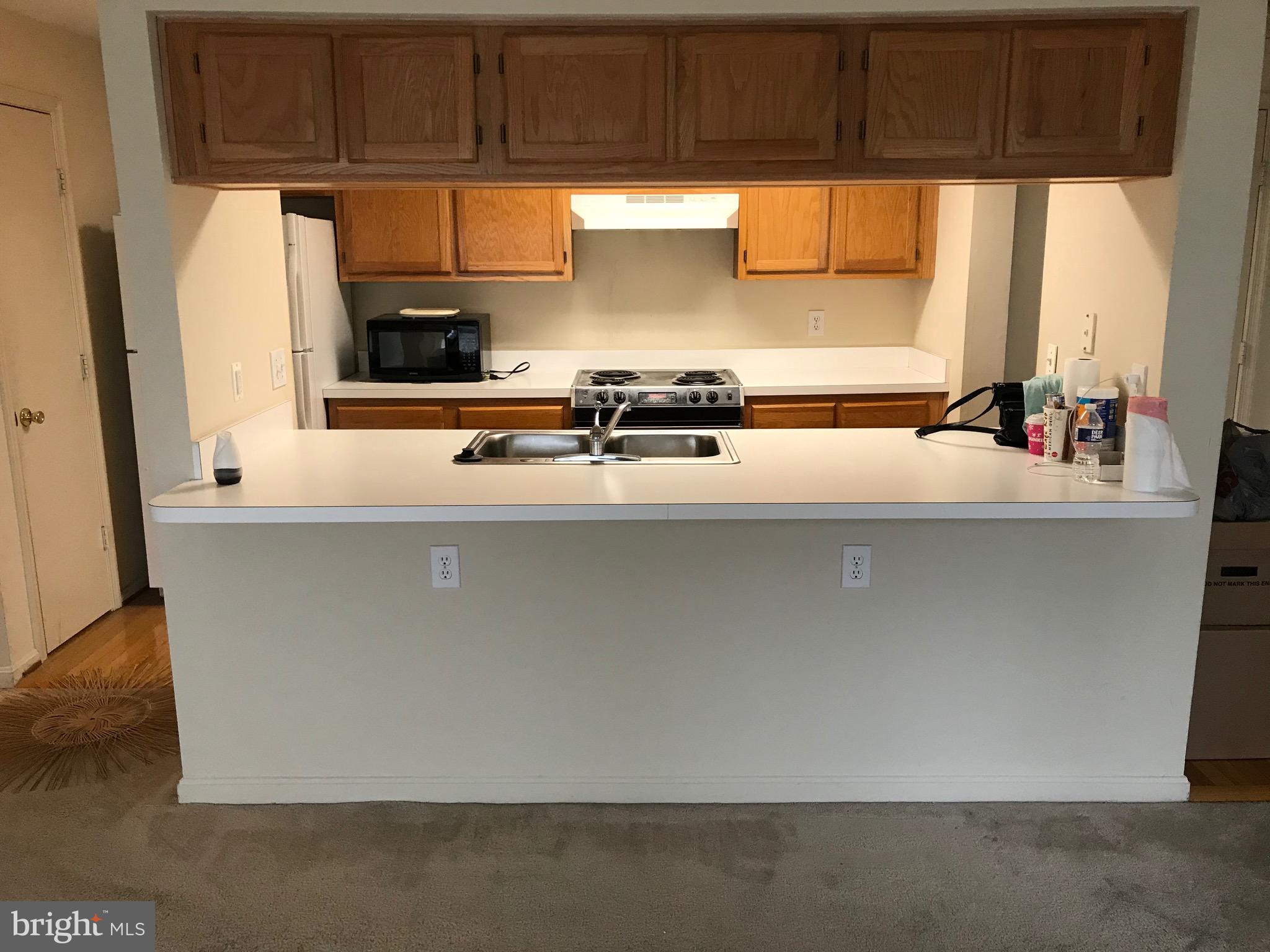 14202 Valleyfield Drive, Unit 8 Silver Spring, MD 20906 - Photo 2 of 19 Living room view of bar / kitchen area