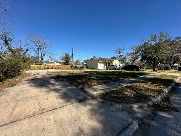 a view of dirt road with a building