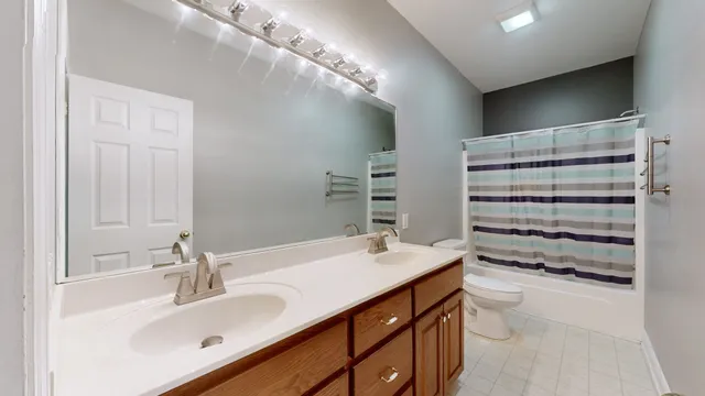 a bathroom with a sink double vanity and a mirror