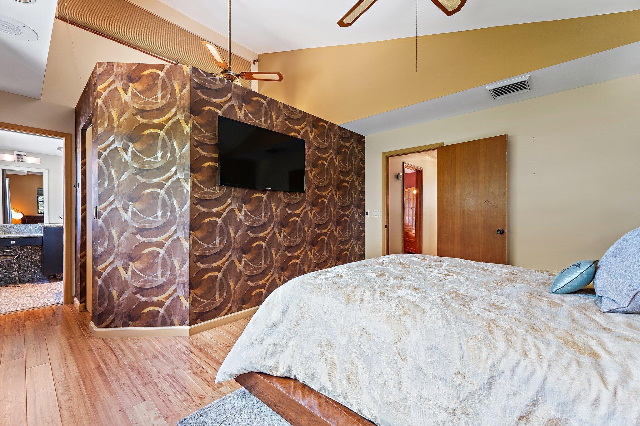702 Warren Drive Jupiter, FL 33458 - Photo 53 of 76 a bedroom with a bed and a flat screen tv