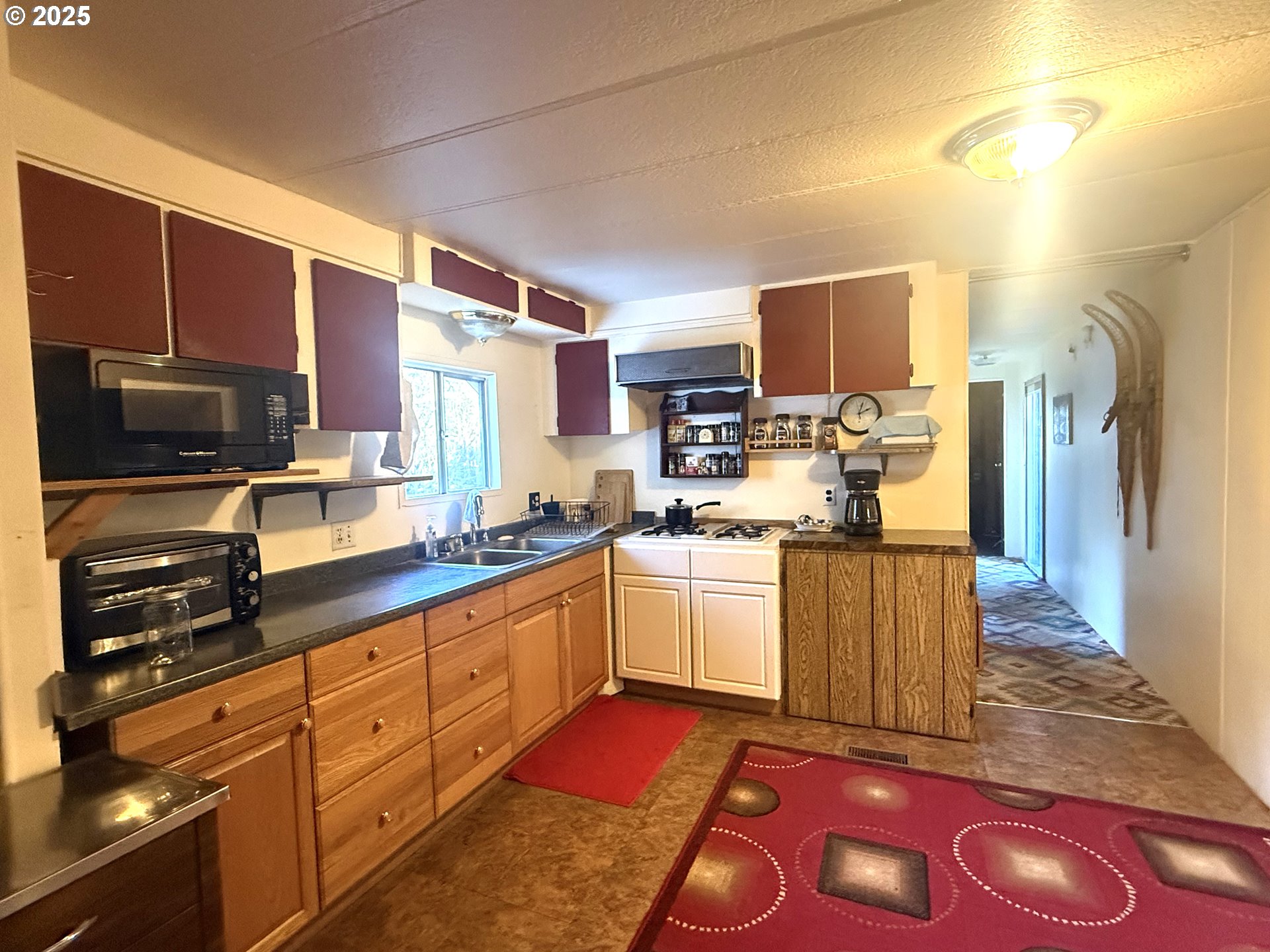 627 Canyon Road Lyle, WA 98635 - Photo 7 of 22 a kitchen with stainless steel appliances granite countertop a sink stove refrigerator and cabinets