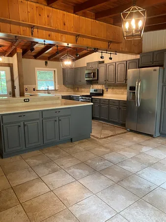 a large kitchen with cabinets and stainless steel appliances