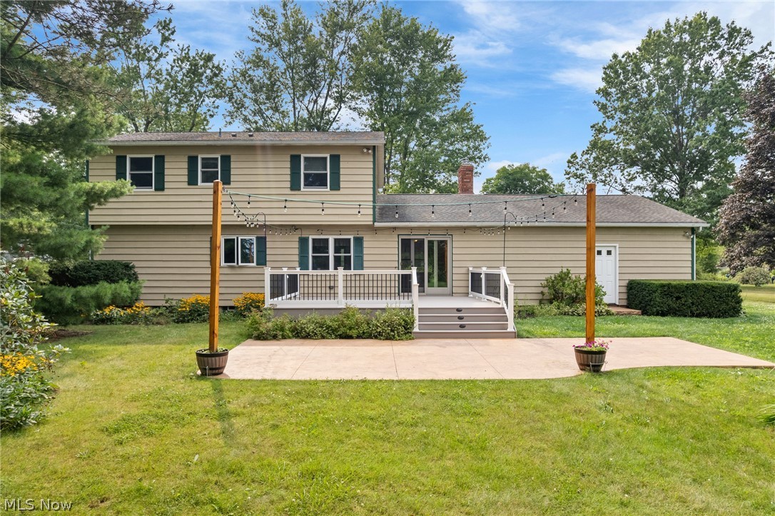 34 Kehner Road Mogadore, OH 44260 - Photo 31 of 40 Expansive rear exterior with light-toned siding, a multi-level deck, and a concrete patio