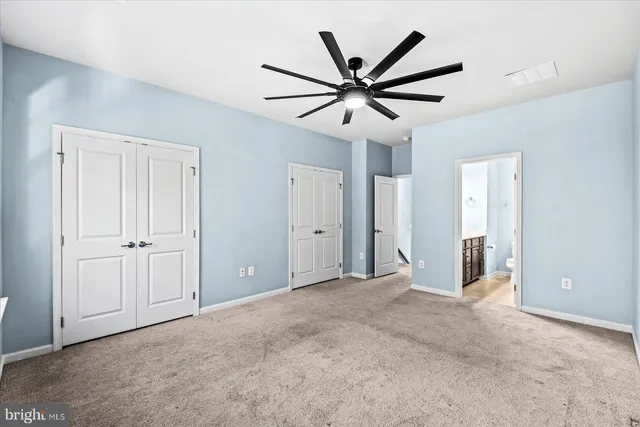 a bathroom with a sink a toilet a mirror and shower