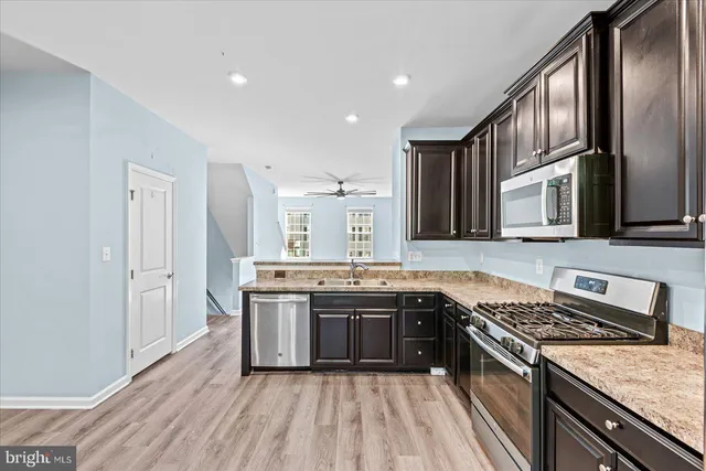 a kitchen with stainless steel appliances granite countertop a stove and a refrigerator
