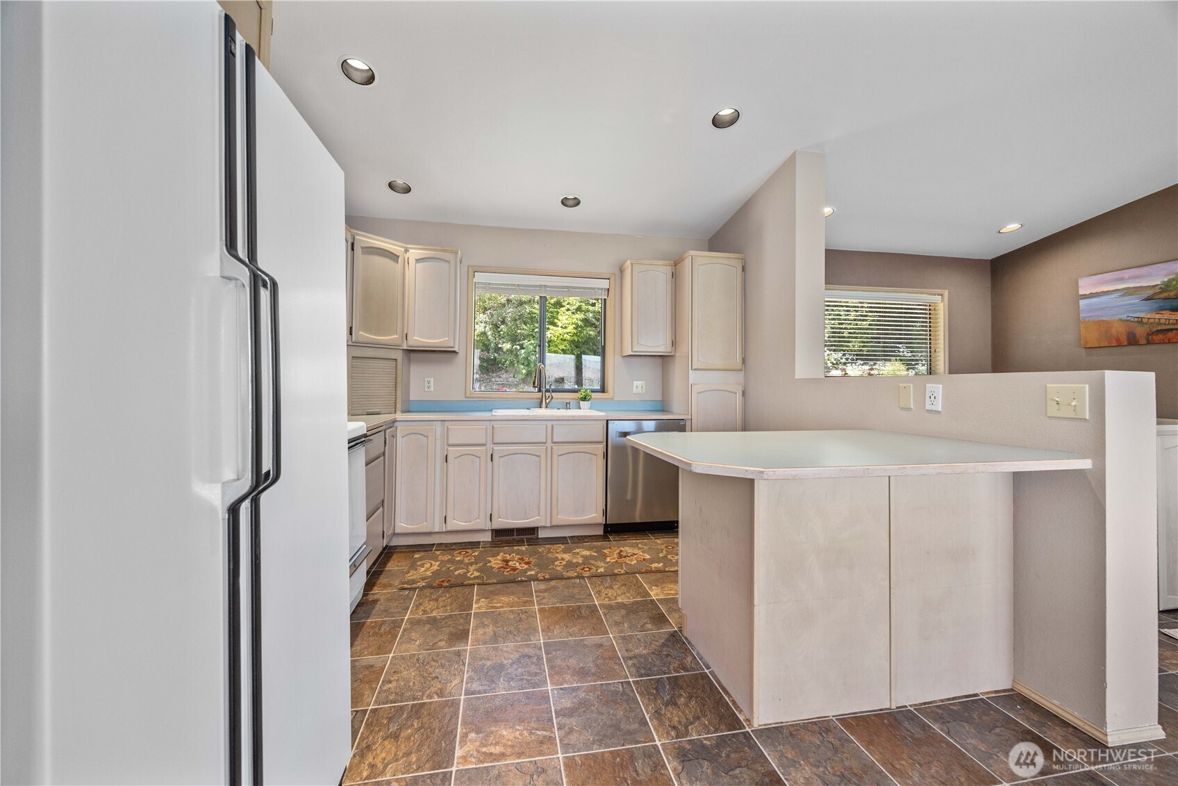 3150 South Lakeshore Road Chelan, WA 98816 - Photo 14 of 36 a kitchen with a sink a window a counter top space stainless steel appliances and cabinets