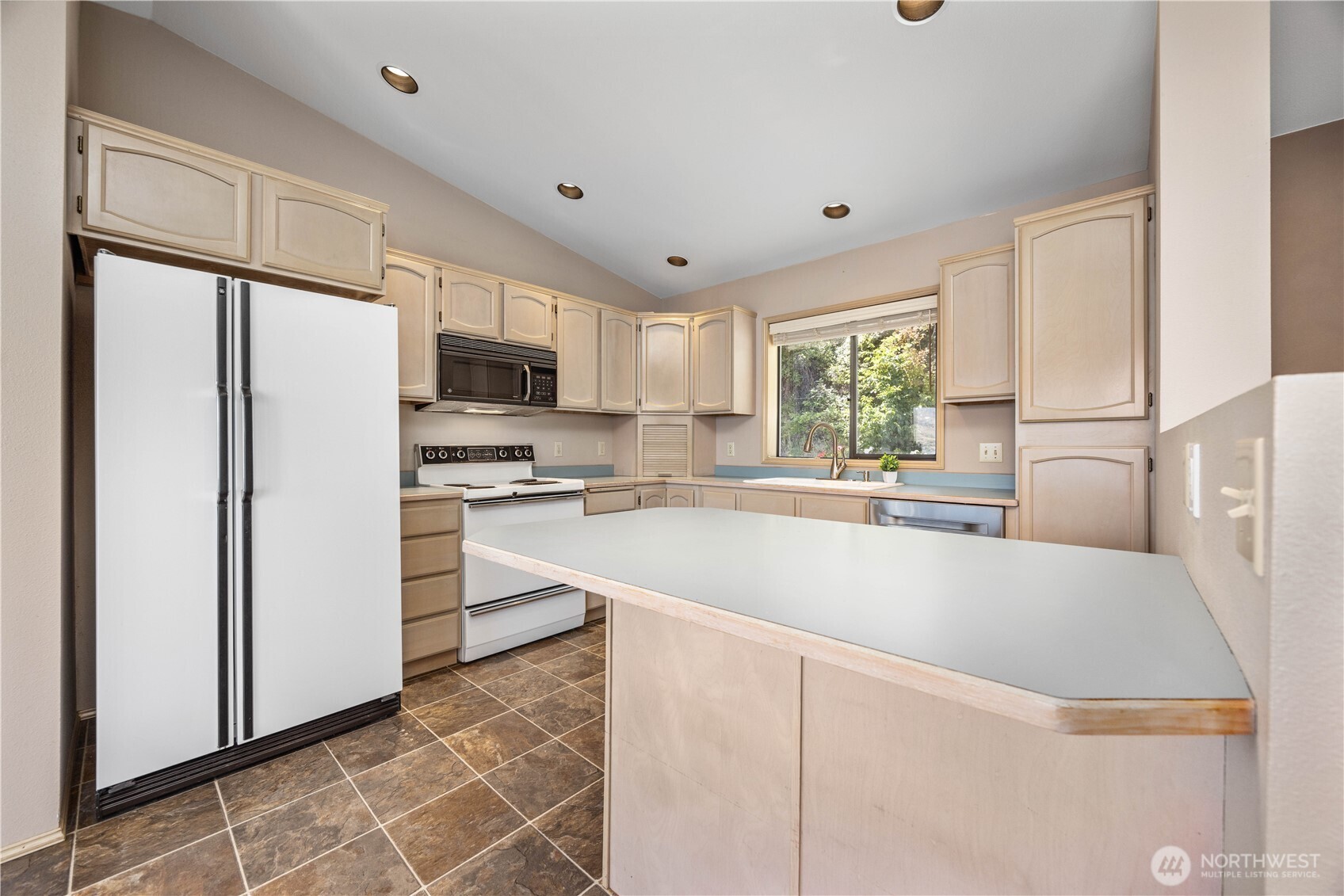 3150 South Lakeshore Road Chelan, WA 98816 - Photo 15 of 36 a kitchen with stainless steel appliances granite countertop a refrigerator a sink a stove a microwave and a refrigerator