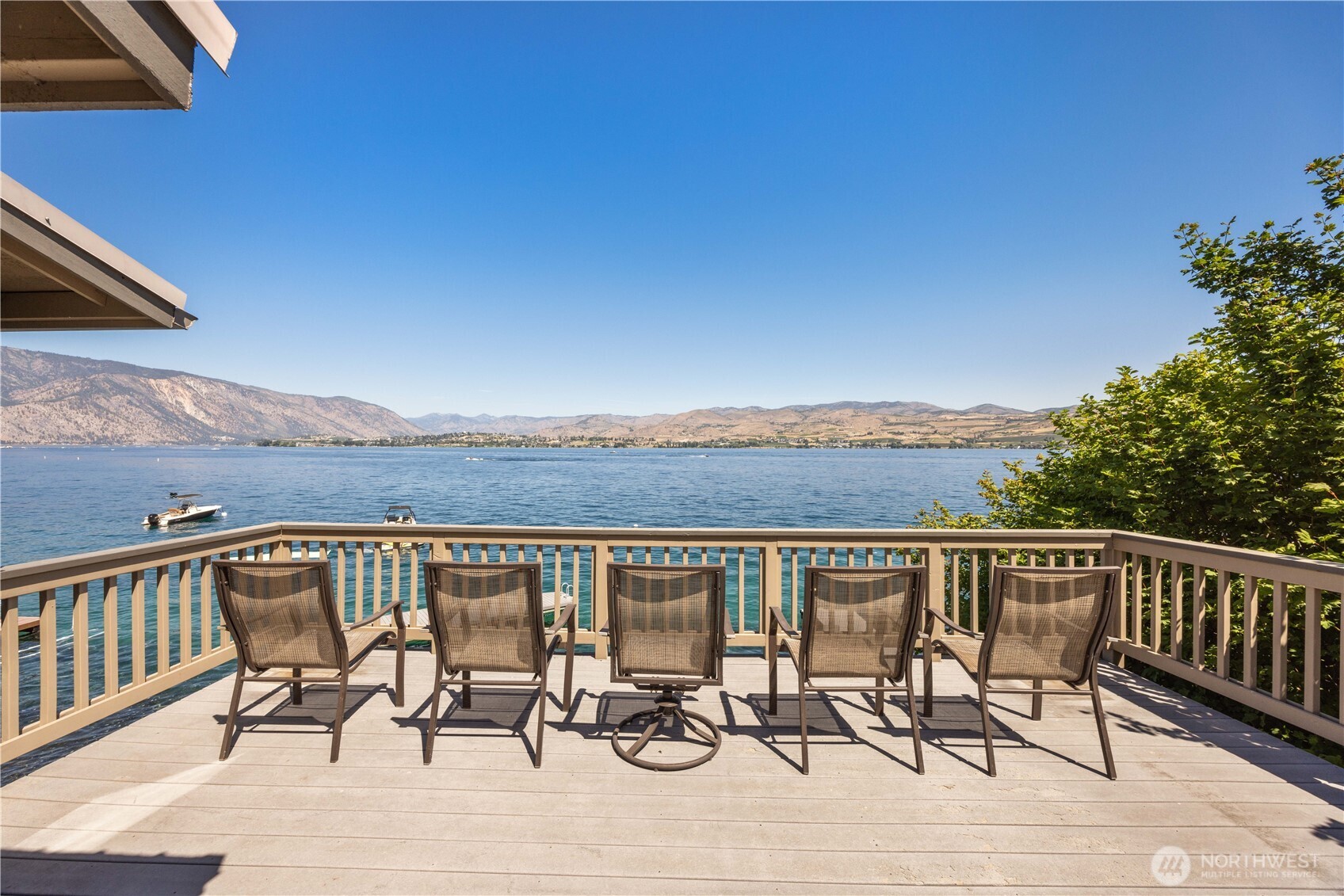 3150 South Lakeshore Road Chelan, WA 98816 - Photo 5 of 36 a view of a chairs and table on wooden deck with lake view