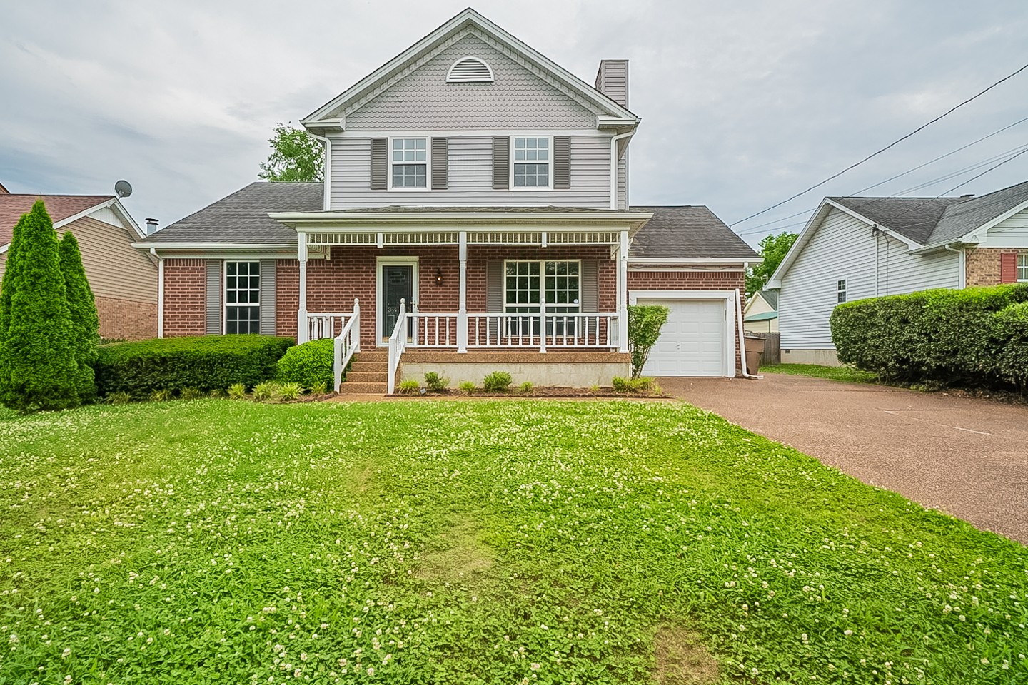 a front view of a house with a garden