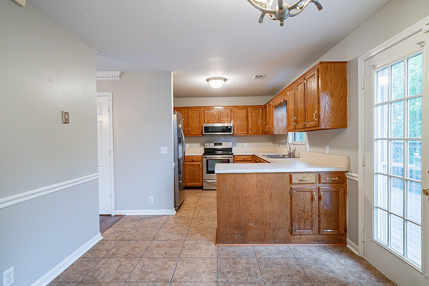 3433 Country Way Road Antioch, TN 37013 - Photo 4 of 29 a kitchen with stainless steel appliances granite countertop a refrigerator a sink dishwasher a stove and white countertops with wooden floor