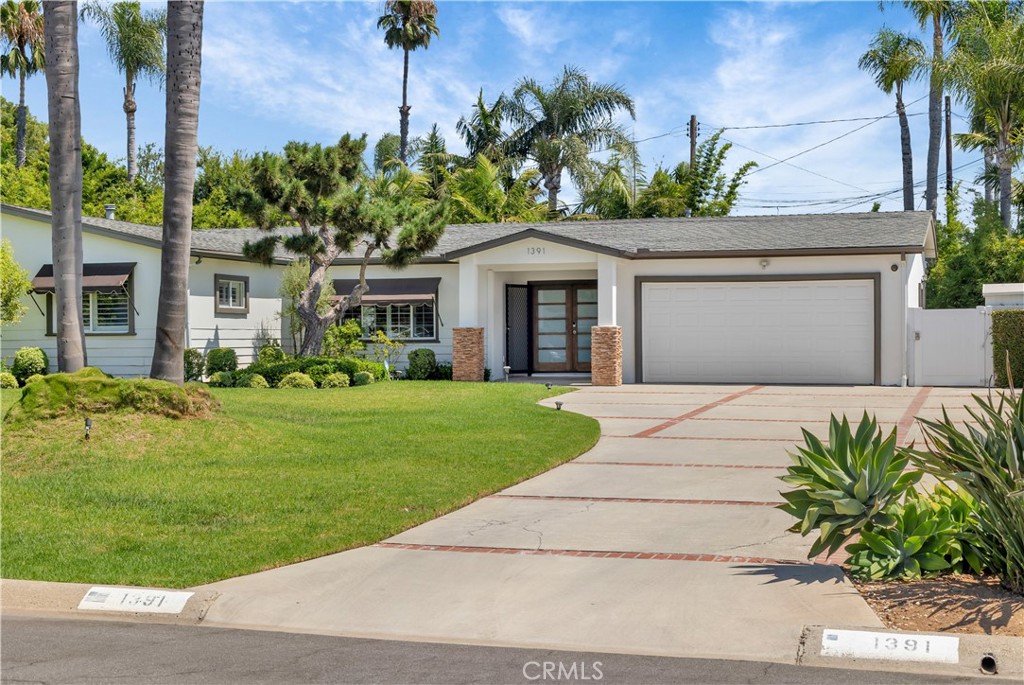 a front view of a house with a garden and plants