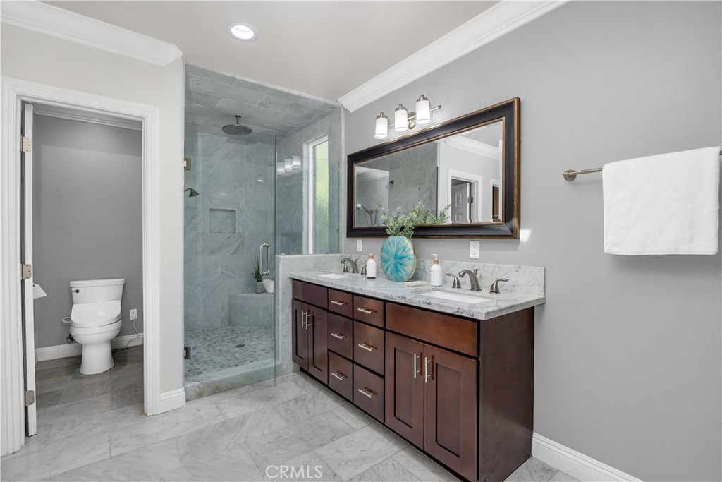 1391 Deborah Drive North Tustin, CA 92705 - Photo 23 of 56 a bathroom with a toilet a sink and mirror