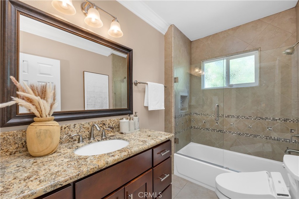 1391 Deborah Drive North Tustin, CA 92705 - Photo 31 of 56 a bathroom with a granite countertop sink and a mirror