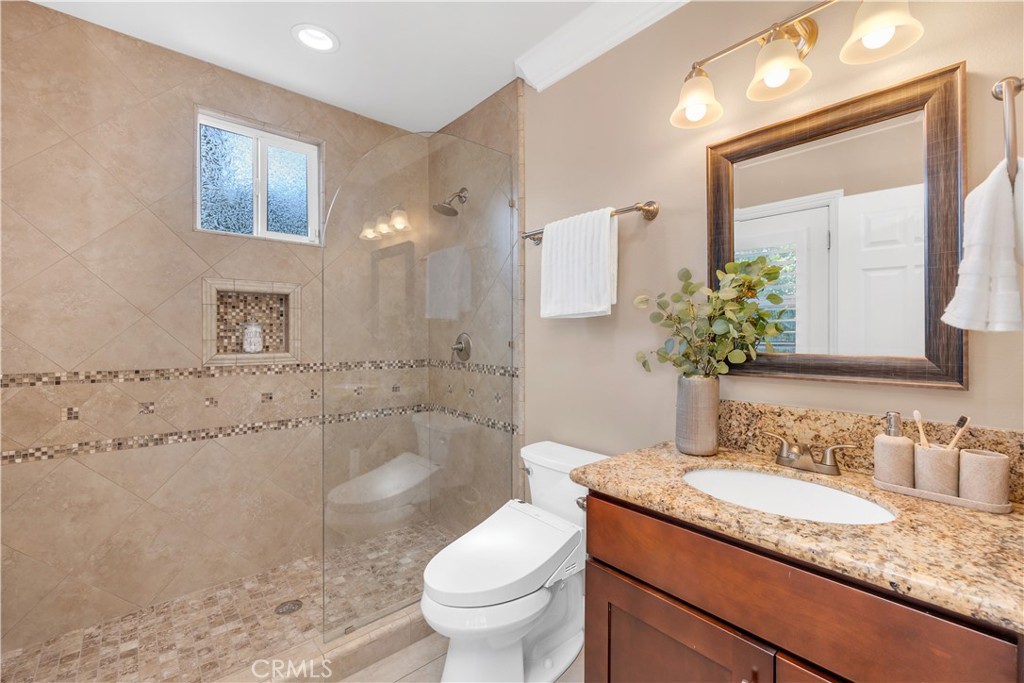 1391 Deborah Drive North Tustin, CA 92705 - Photo 32 of 56 a bathroom with a granite countertop sink mirror vanity and toilet
