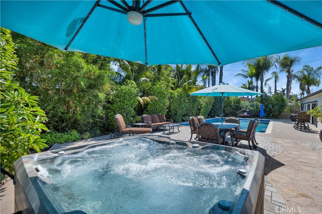 1391 Deborah Drive North Tustin, CA 92705 - Photo 38 of 56 a view of a patio with table and chairs under an umbrella