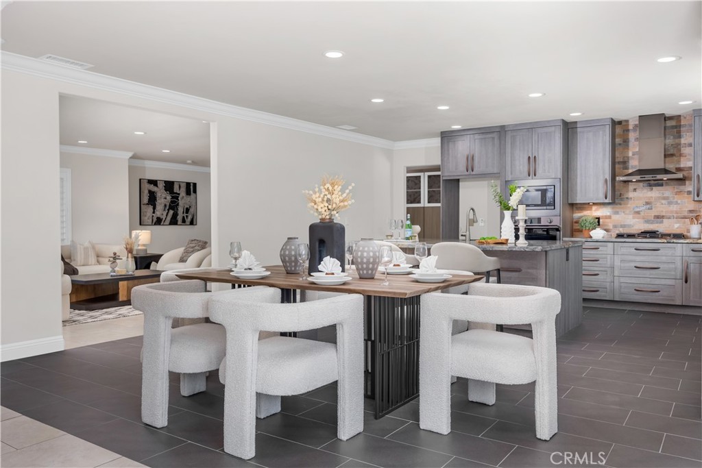 1391 Deborah Drive North Tustin, CA 92705 - Photo 10 of 56 a dining room with stainless steel appliances kitchen island granite countertop a table and chairs