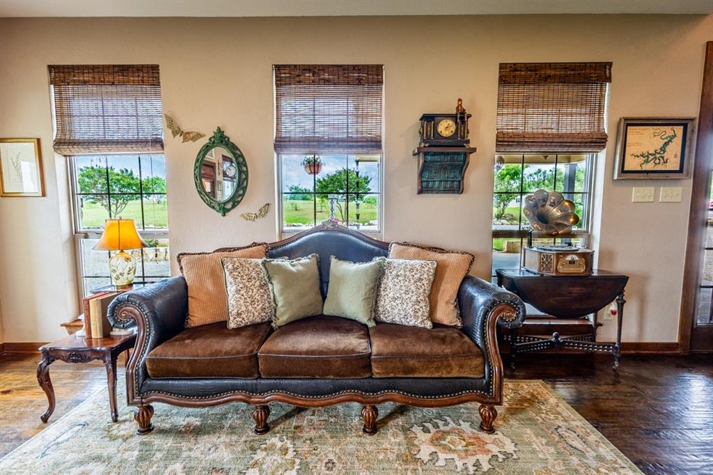 7060 Hells Gate Loop Strawn, TX 76475 - Photo 3 of 40 a living room with furniture and wooden floor