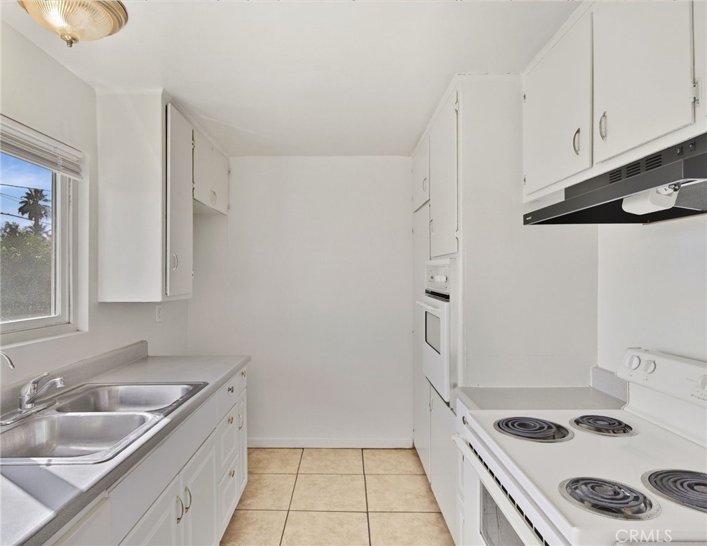 2032 West Linden Street Riverside, CA 92507 - Photo 55 of 66 a kitchen with a sink a stove and refrigerator