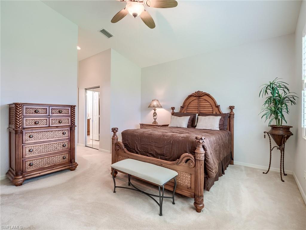 9460 Sun River Way Estero, FL 33928 - Photo 13 of 41 a bedroom with a bed and a chandelier