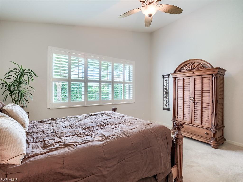 9460 Sun River Way Estero, FL 33928 - Photo 14 of 41 a bedroom with a bed and a chandelier