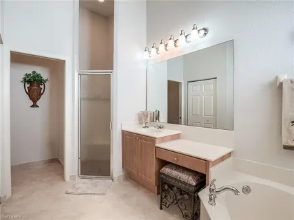 a bathroom with a sink a tub and a mirror