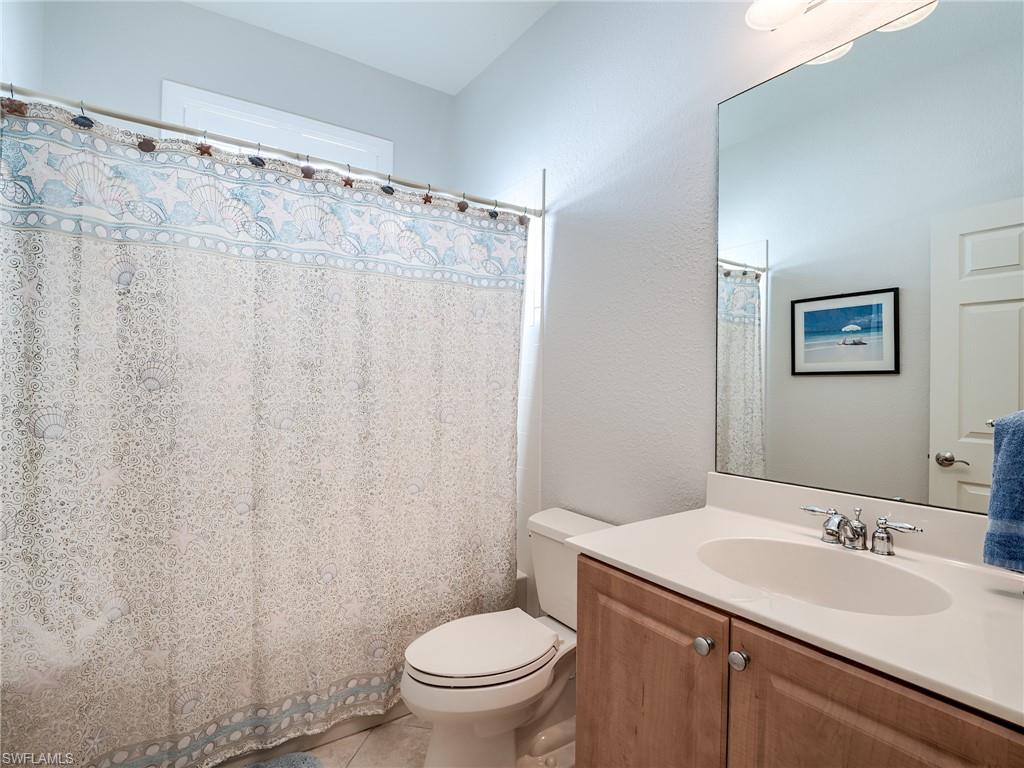 9460 Sun River Way Estero, FL 33928 - Photo 20 of 41 a bathroom with a sink a toilet and a mirror