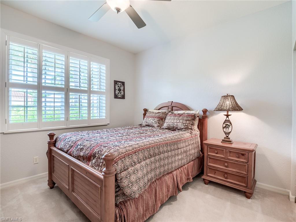 9460 Sun River Way Estero, FL 33928 - Photo 21 of 41 a bedroom with a bed and a window