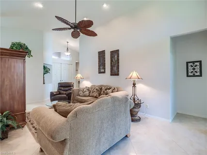 a kitchen with granite countertop a sink a counter top space stainless steel appliances and cabinets