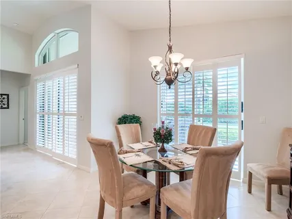a view of a dining room with furniture wooden floor and chandelier