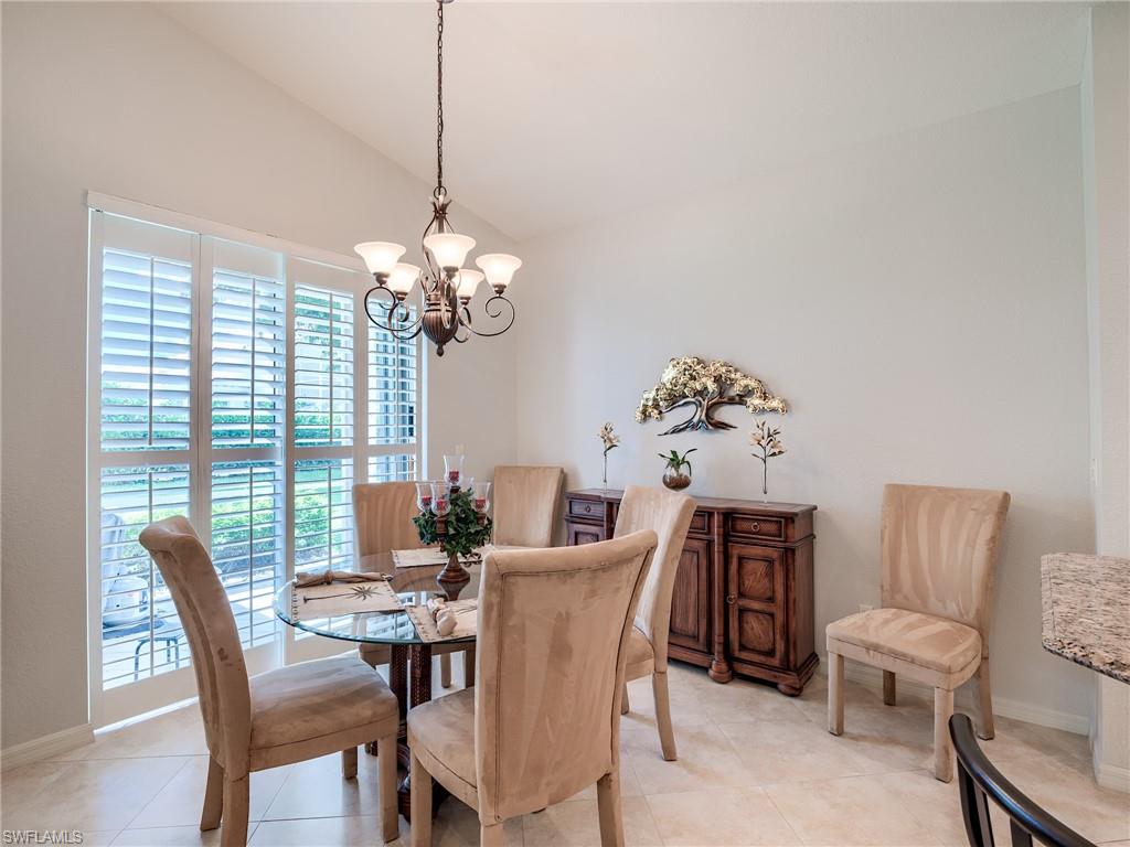 9460 Sun River Way Estero, FL 33928 - Photo 10 of 41 a dining room with furniture a large window and wooden floor