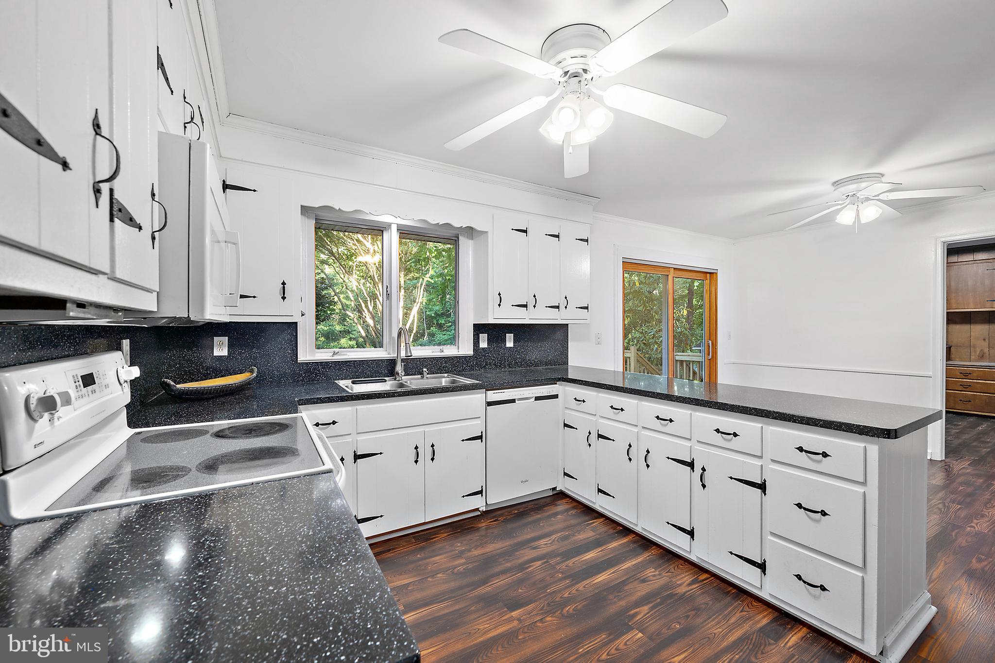 6181 Rockawalkin Road Salisbury, MD 21801 - Photo 18 of 65 a kitchen with granite countertop white cabinets white appliances with a sink and dishwasher