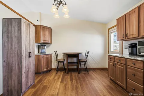 a view of an empty room with window and bathroom