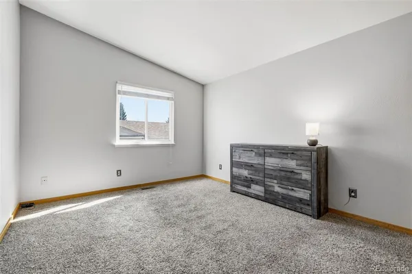 a view of an empty room with closet area