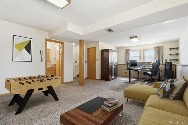 a living room with furniture rug and a window