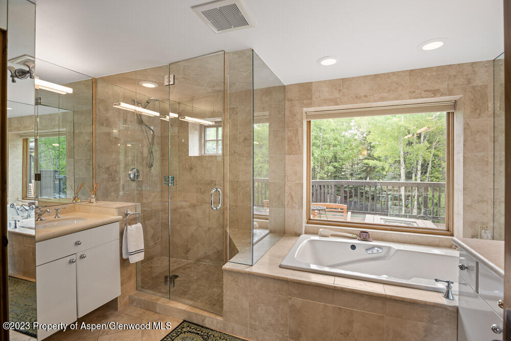 64 Eastwood Road Aspen, CO 81611 - Photo 17 of 24 a spacious bathroom with a tub sink shower and mirror