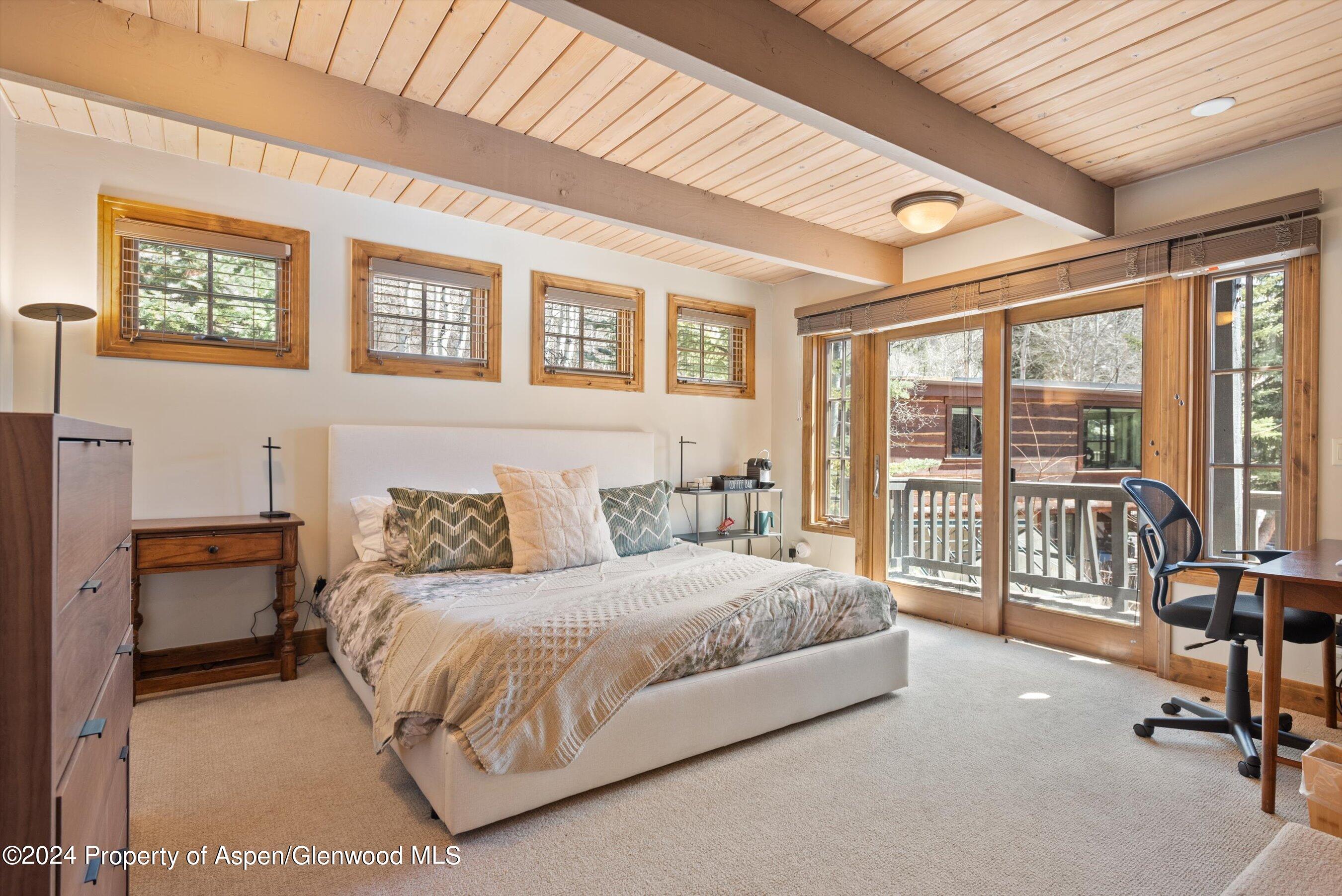 64 Eastwood Road Aspen, CO 81611 - Photo 21 of 24 a bedroom with a bed and a large window