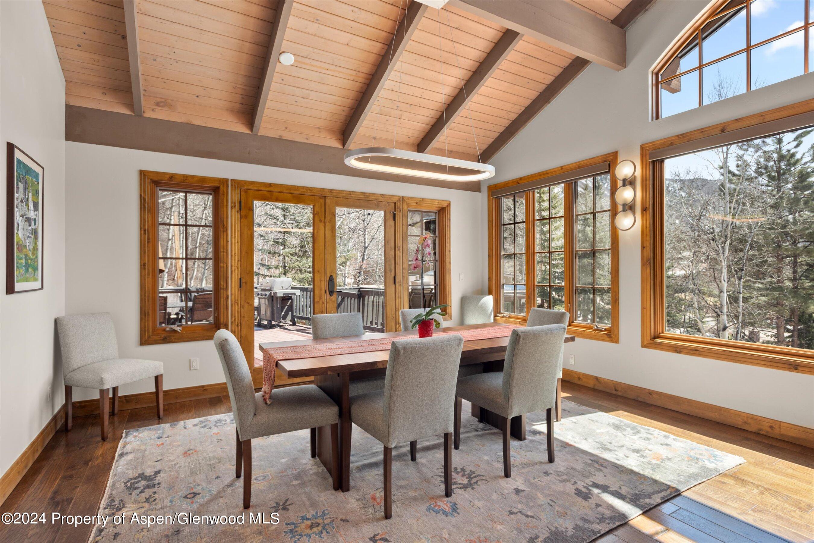 64 Eastwood Road Aspen, CO 81611 - Photo 5 of 24 a dining room with furniture a rug and a large window