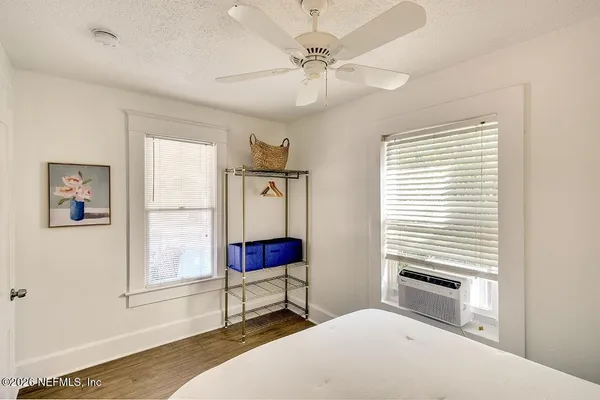 a living room with furniture and a painting on the wall